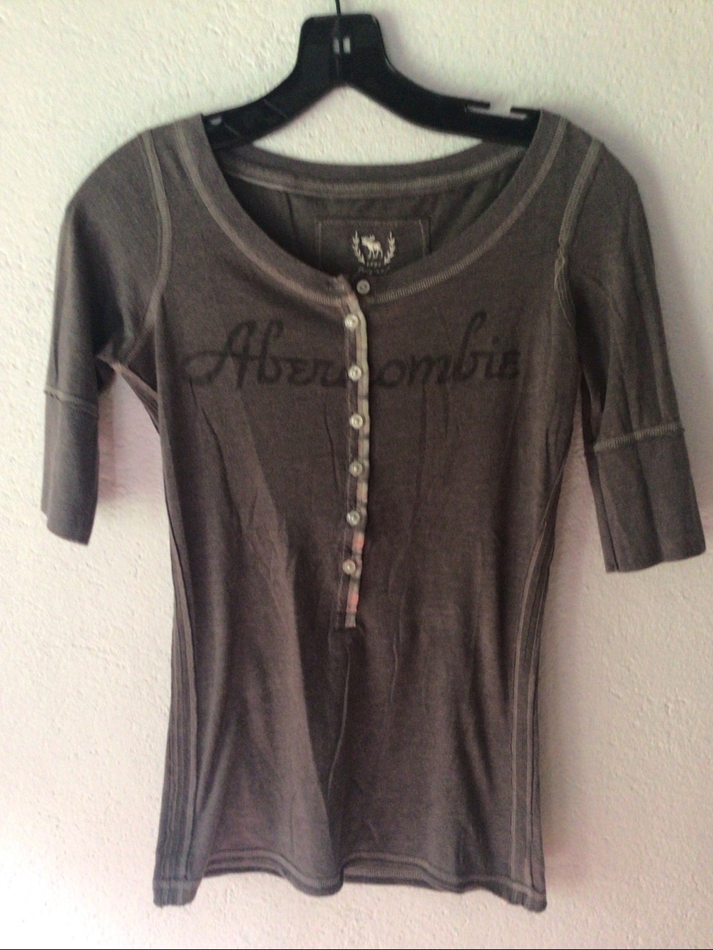 Abercrombie & Fitch Henley Tee Charcoal Gray withsatin trim near buttons.